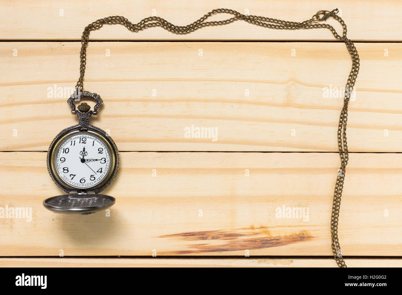 Top View Antique clock placed on a wooden floor. Stock Photo