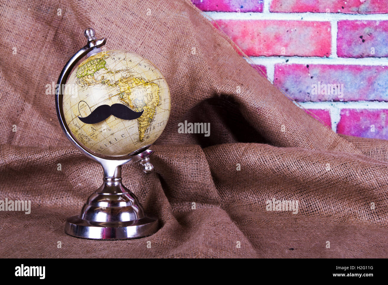 Globe with a comedy black hipster mustache Stock Photo