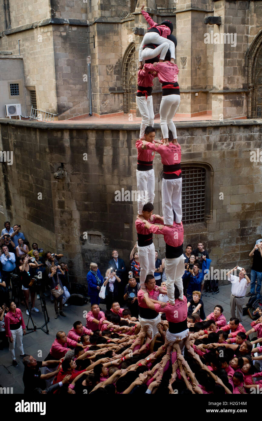 Members of the chinese Colla Xiquets de Hangzhou prepare to build a human tower in Barcelona, Spain. Stock Photo