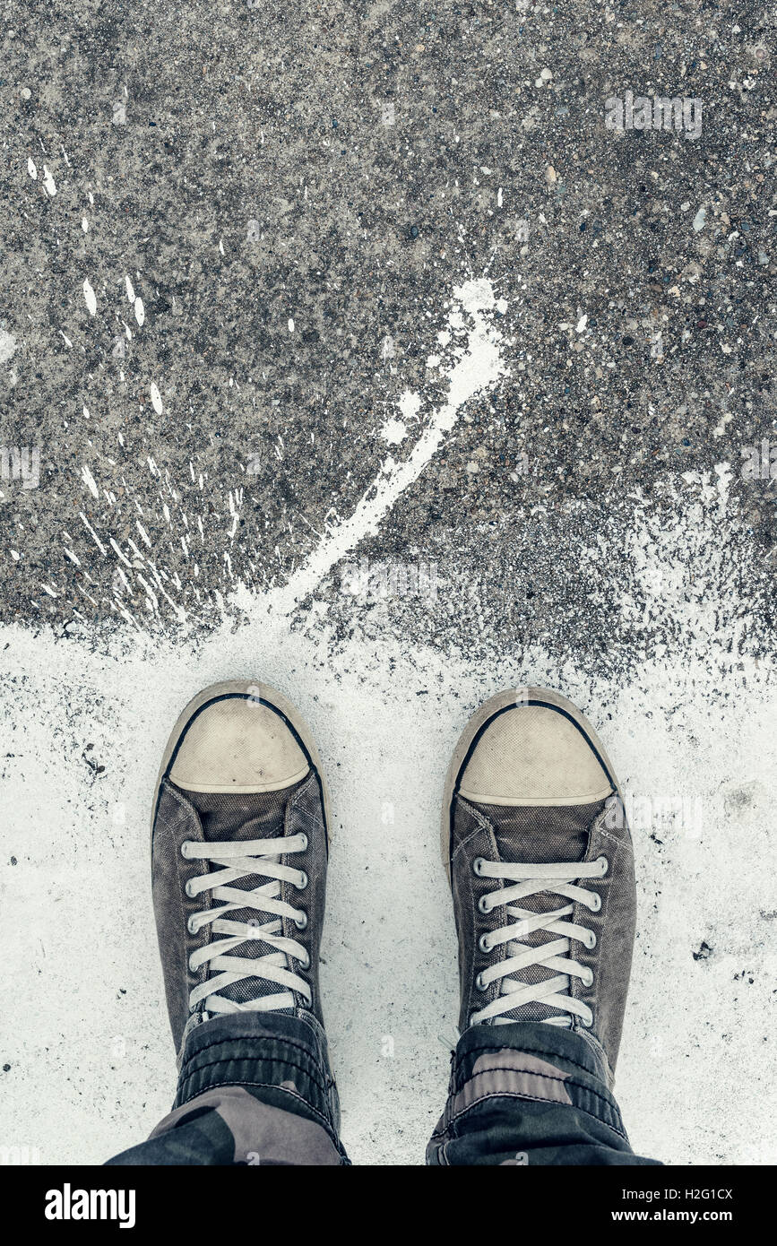 Urban city youth lifestyle concept, top view of sneakers on the concrete flooring with white paint stains Stock Photo