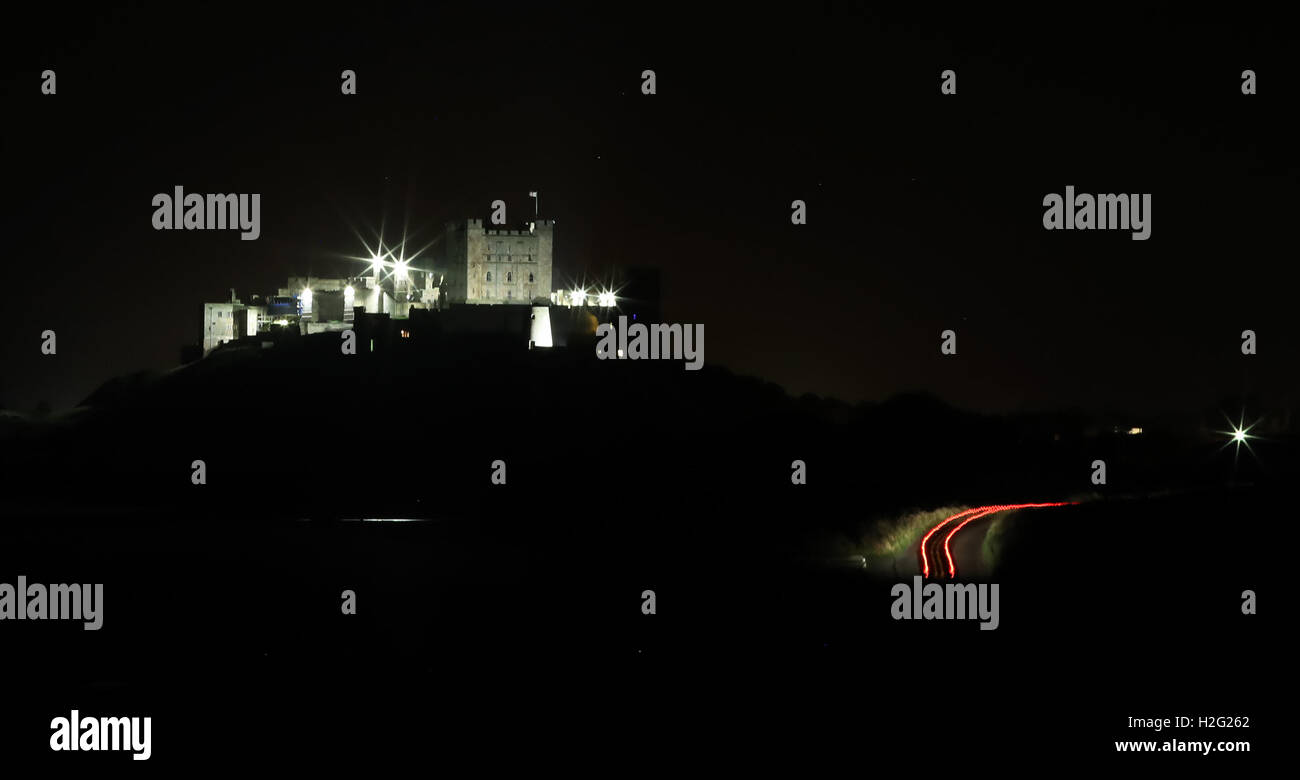 A car passes Bamburgh Castle in Northumberland last night. Stock Photo