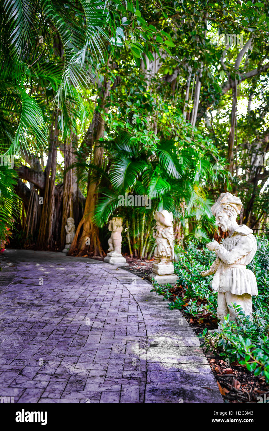 Statues line the brick path through a Banyan tree grove on the grounds of the Ringling Museum of Art in Sarasota, FL Stock Photo