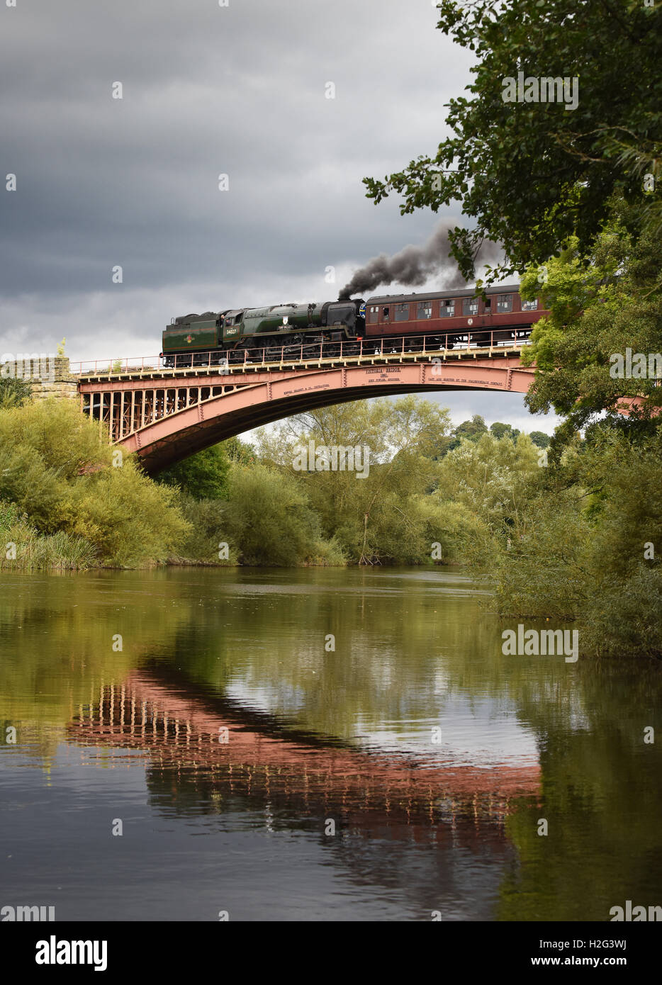 The Taw Valley steam locomotive crossing the River Severn on the Severn Valley Railway Victoria Bridge at Arley in Shropshire. Stock Photo