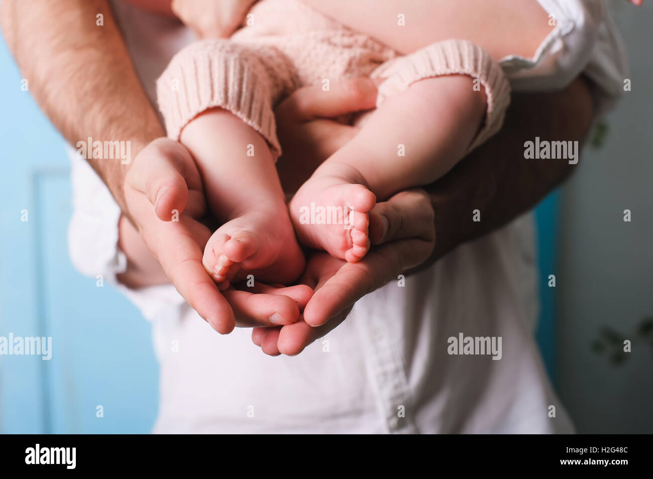 Dad holding newborn daughter. Father's hands holding and showing his