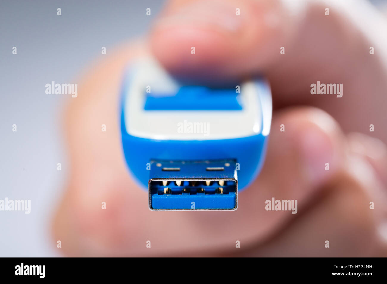 A child sharing digital computer files on a USB Stick Stock Photo