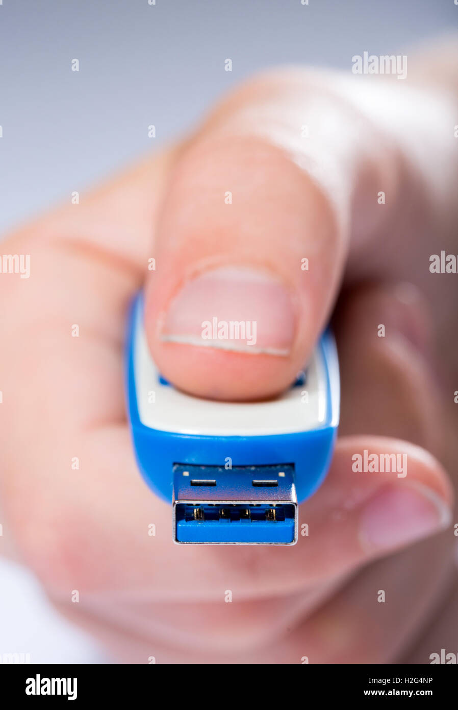 A child sharing digital computer files on a USB Stick Stock Photo