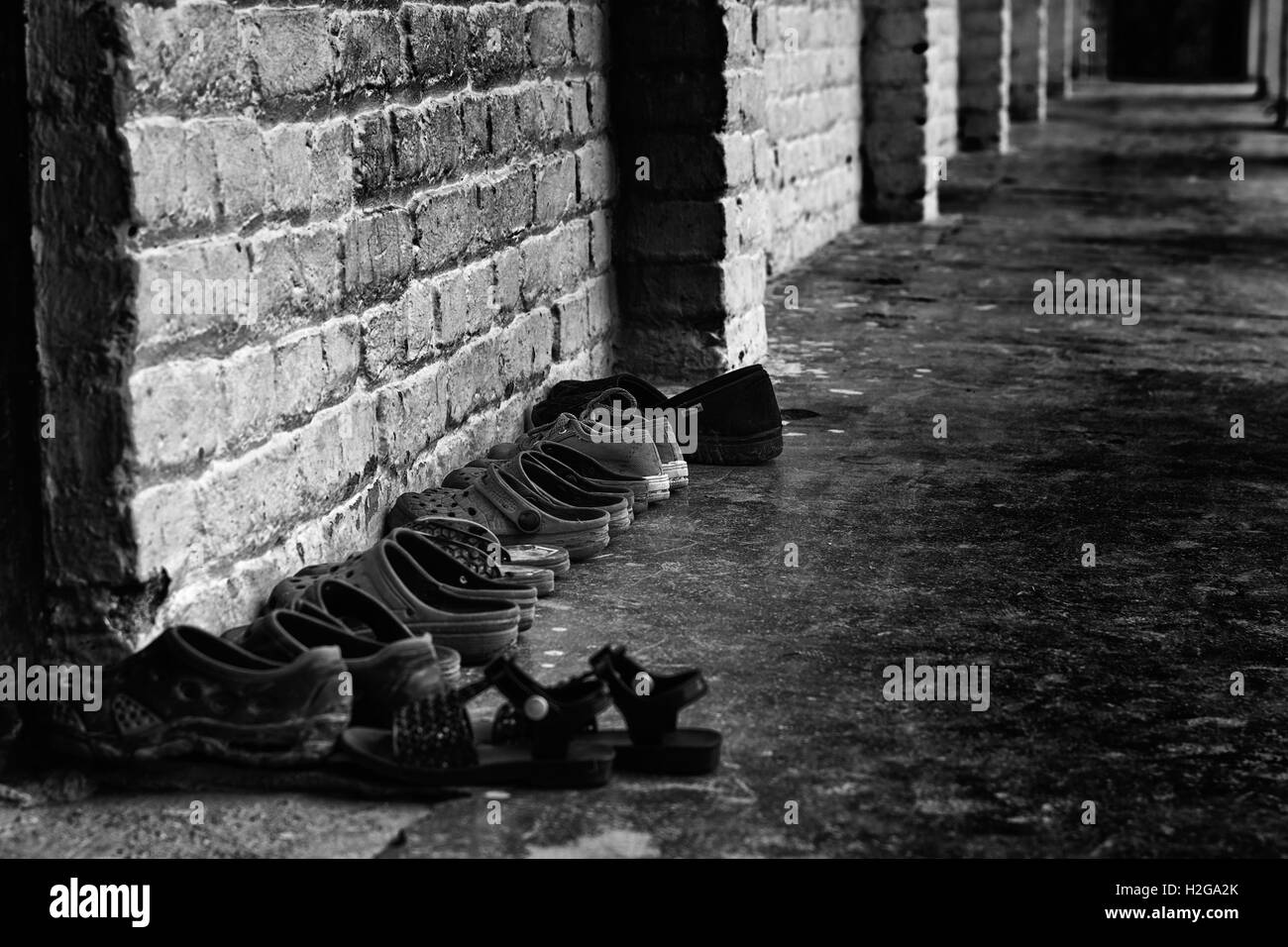 Shoes lines up outside of a classroom in Dhulikhel Nepal Stock Photo