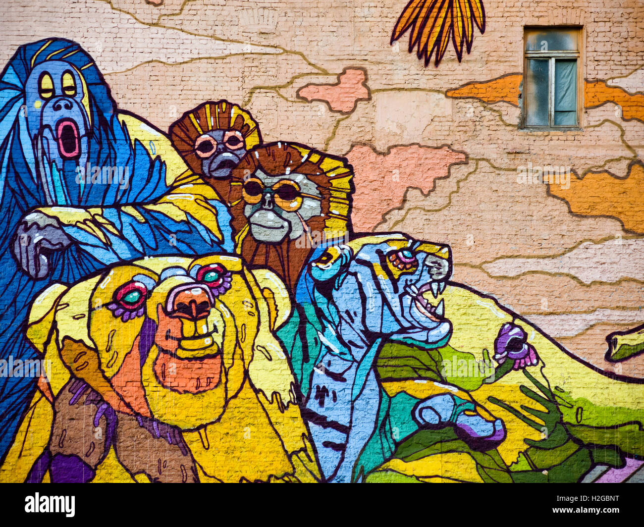 Massive graffiti, jungle and exotic animals, on an old building wall