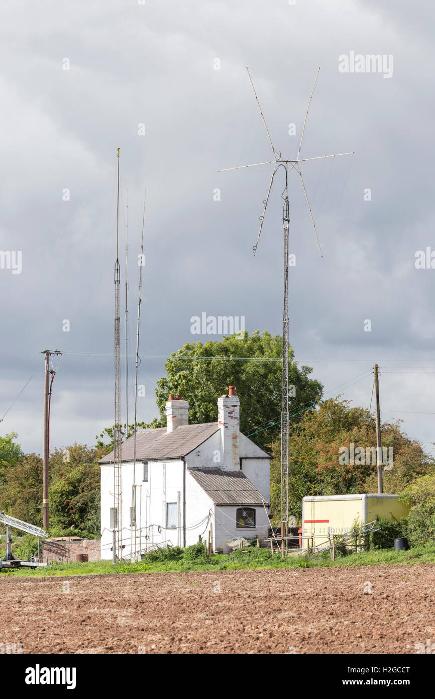 A amateur radio enthusiasts country cottage with radio masts, England, UK Stock Photo