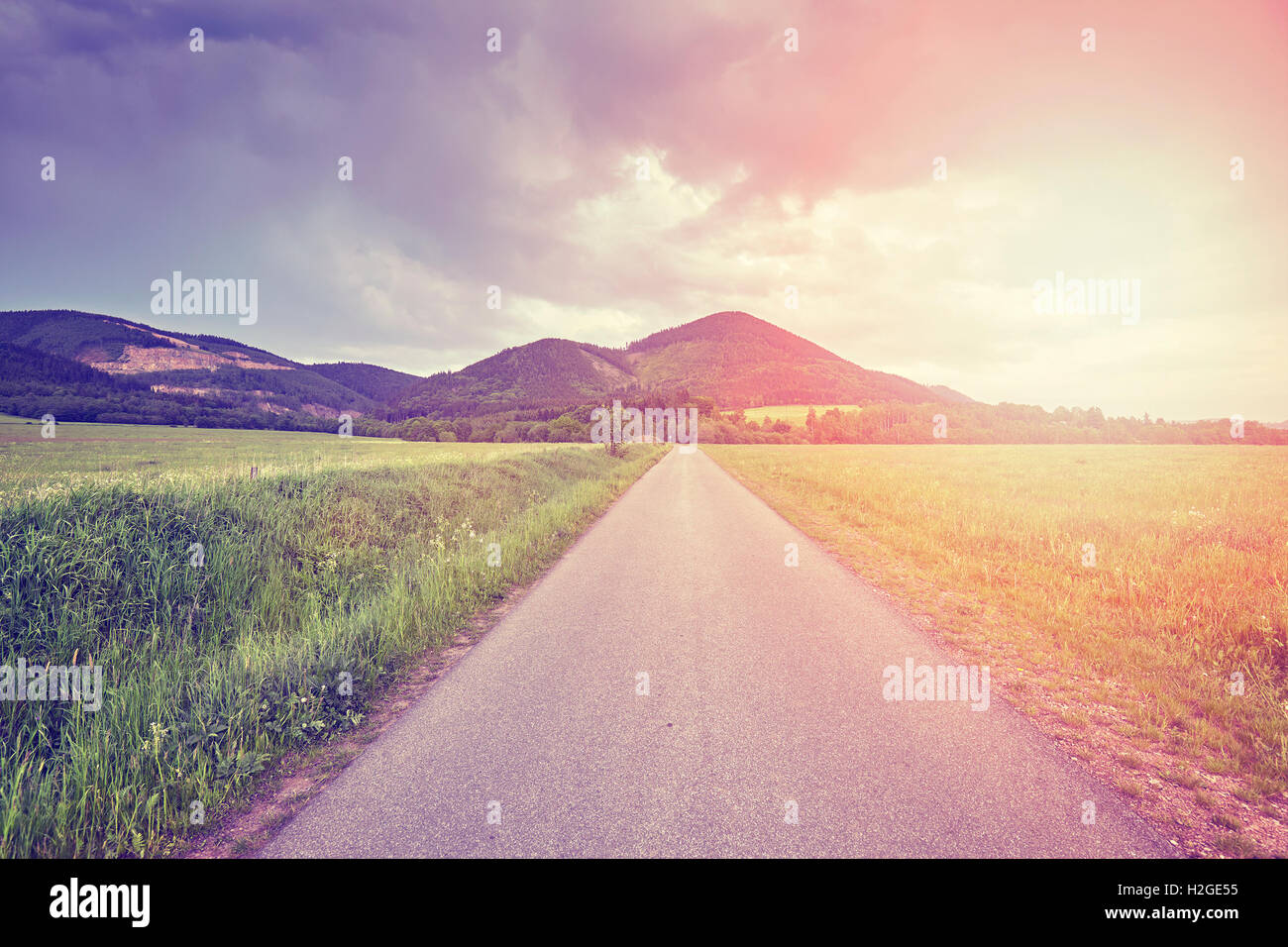 Vintage toned countryside road at sunset Stock Photo - Alamy