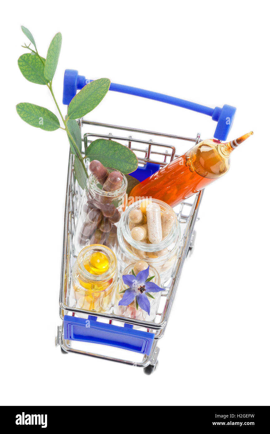 Shopping cart full of pharmaceutical drug ,medicine pills ,plants and food supplement Stock Photo