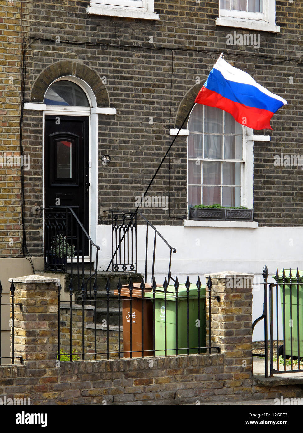 A Russian flag flies outside a house entrance in south east London, UK. Stock Photo