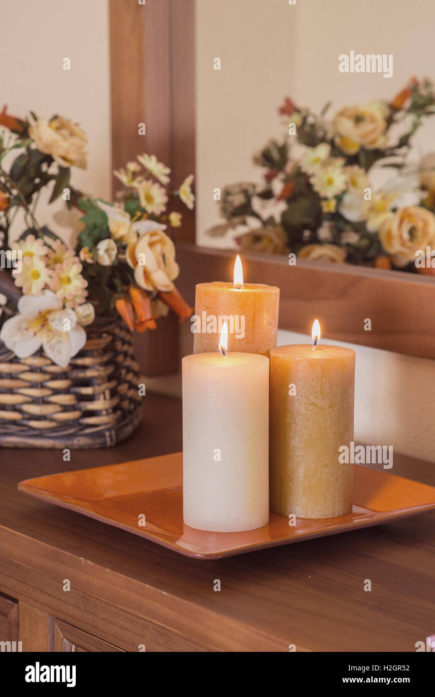 tray decorated with candles on a sideboard. toned image Stock Photo
