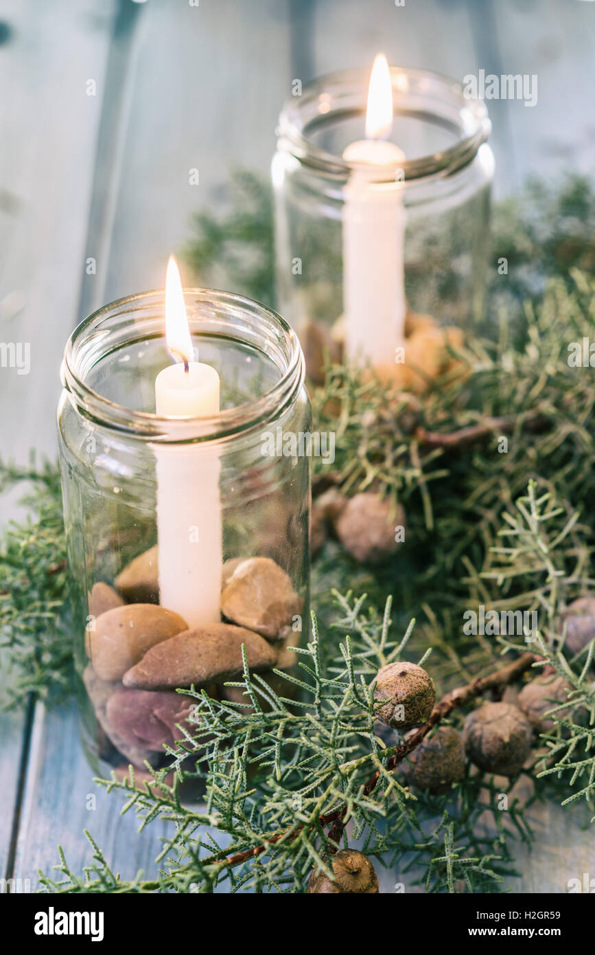 Christmas ornament with burning candles and juniper berries Stock Photo