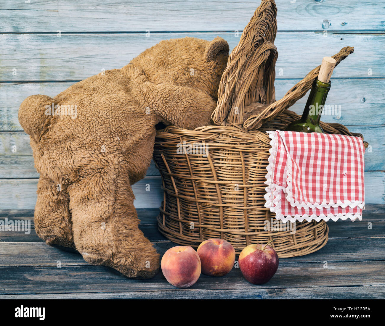 teddy bear snooping inside a picnic basket Stock Photo