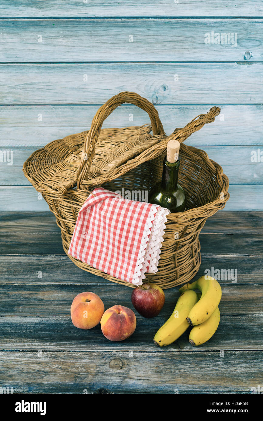 picnic basket with fresh fruit and bottle of wine Stock Photo - Alamy