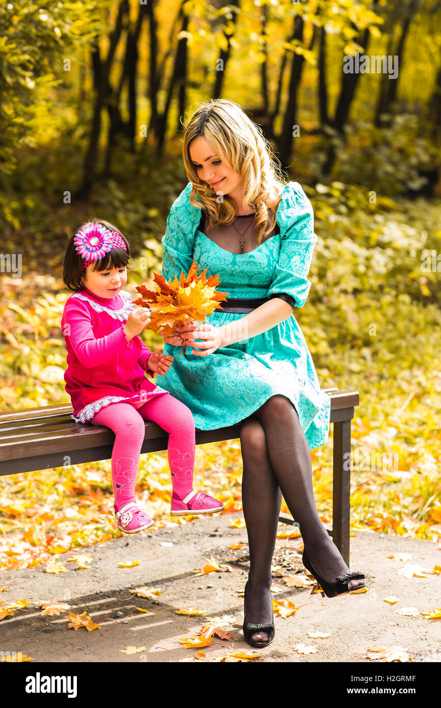 Mother and daughter in the autumn park Stock Photo - Alamy