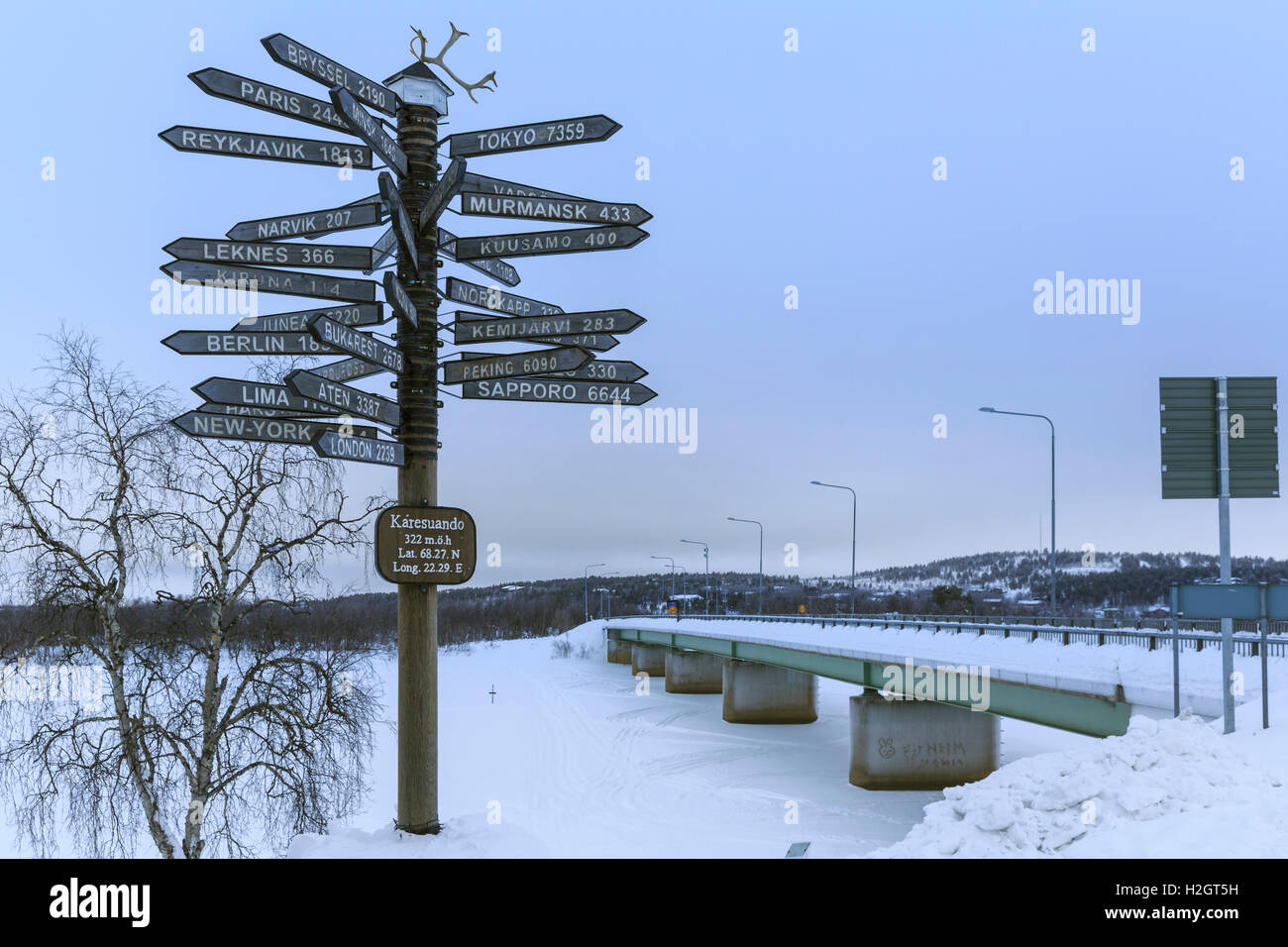 Signpost pointing in all directions, bridge across River Munio behind, Karesuando, Norrbotten