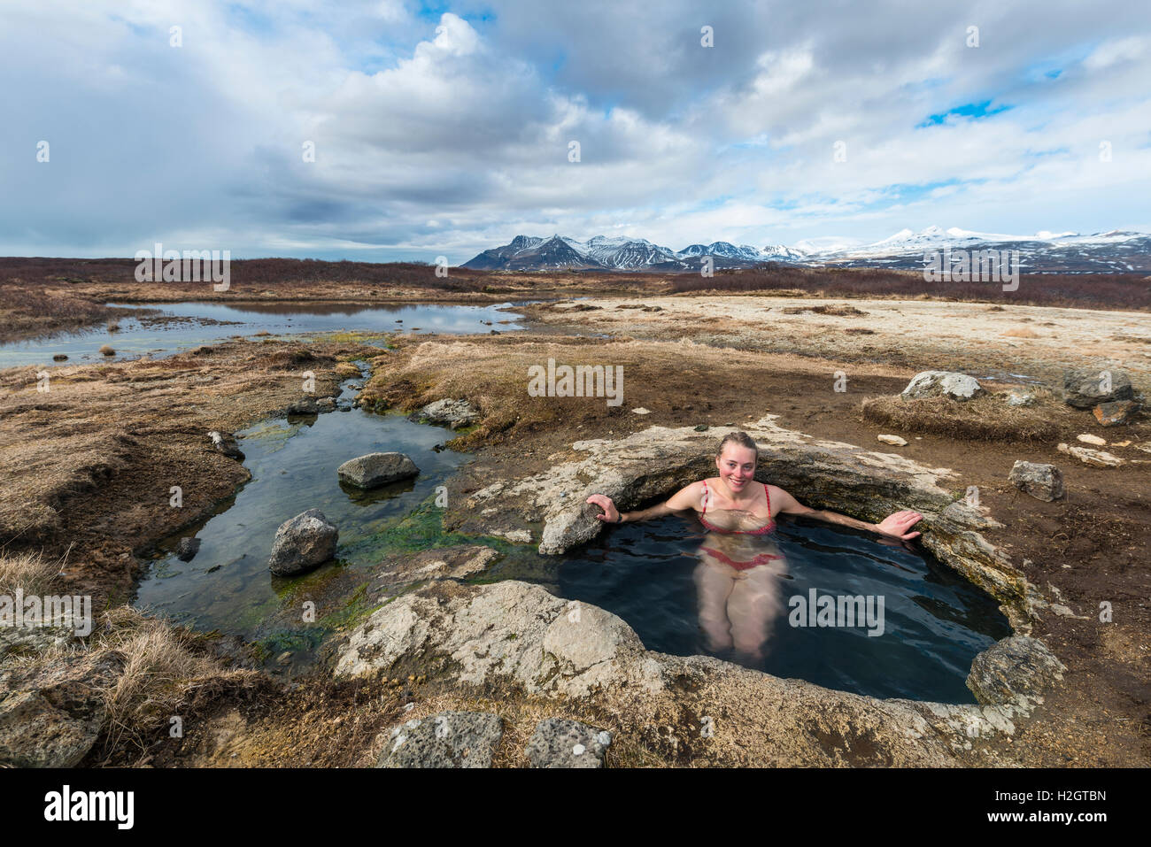 Young woman in hot spring, Eyjar og Miklaholt, Western Region, Iceland Stock Photo