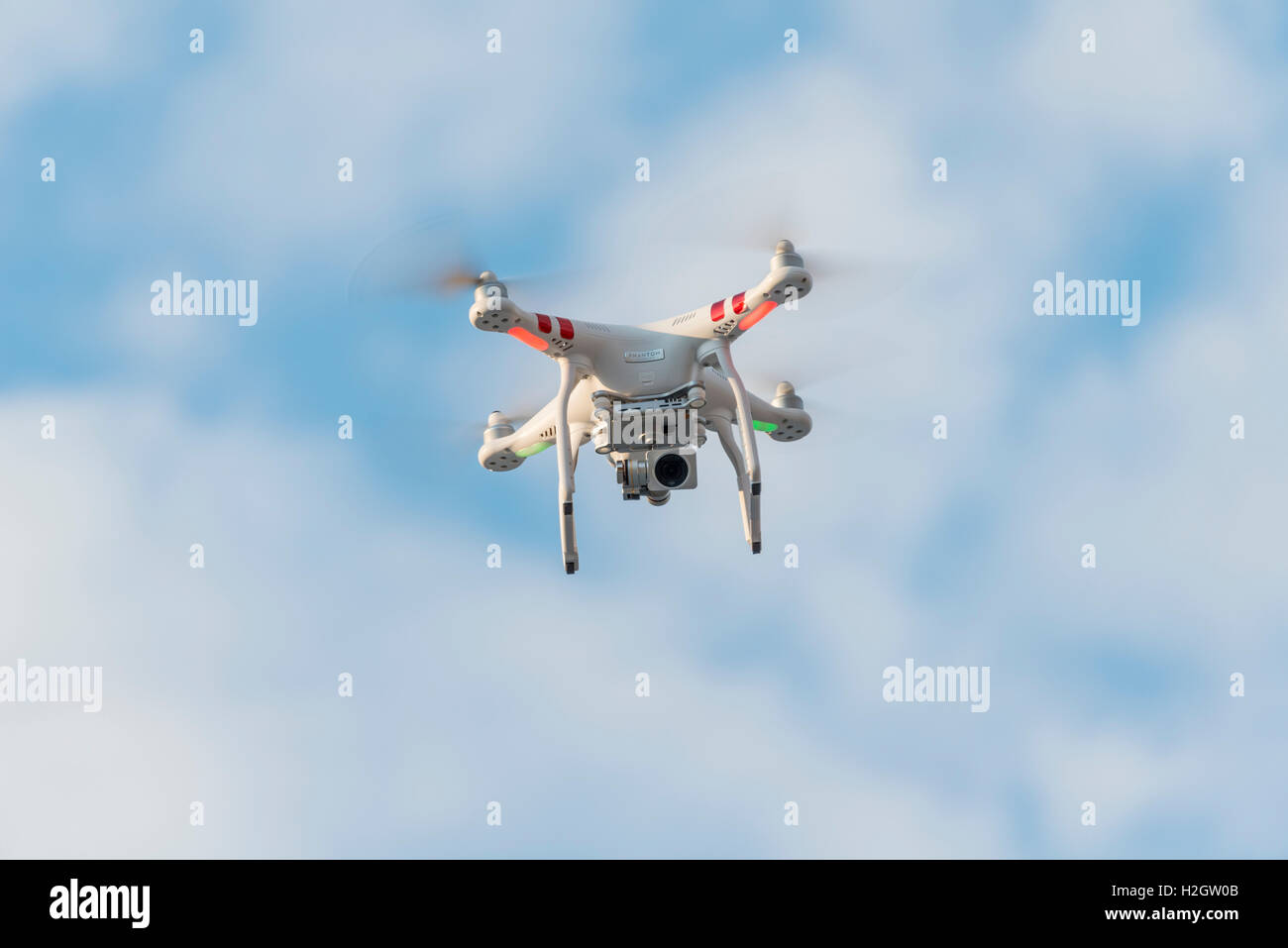 Quadcopter, drone with camera flying in front of blue sky, DJI Phantom