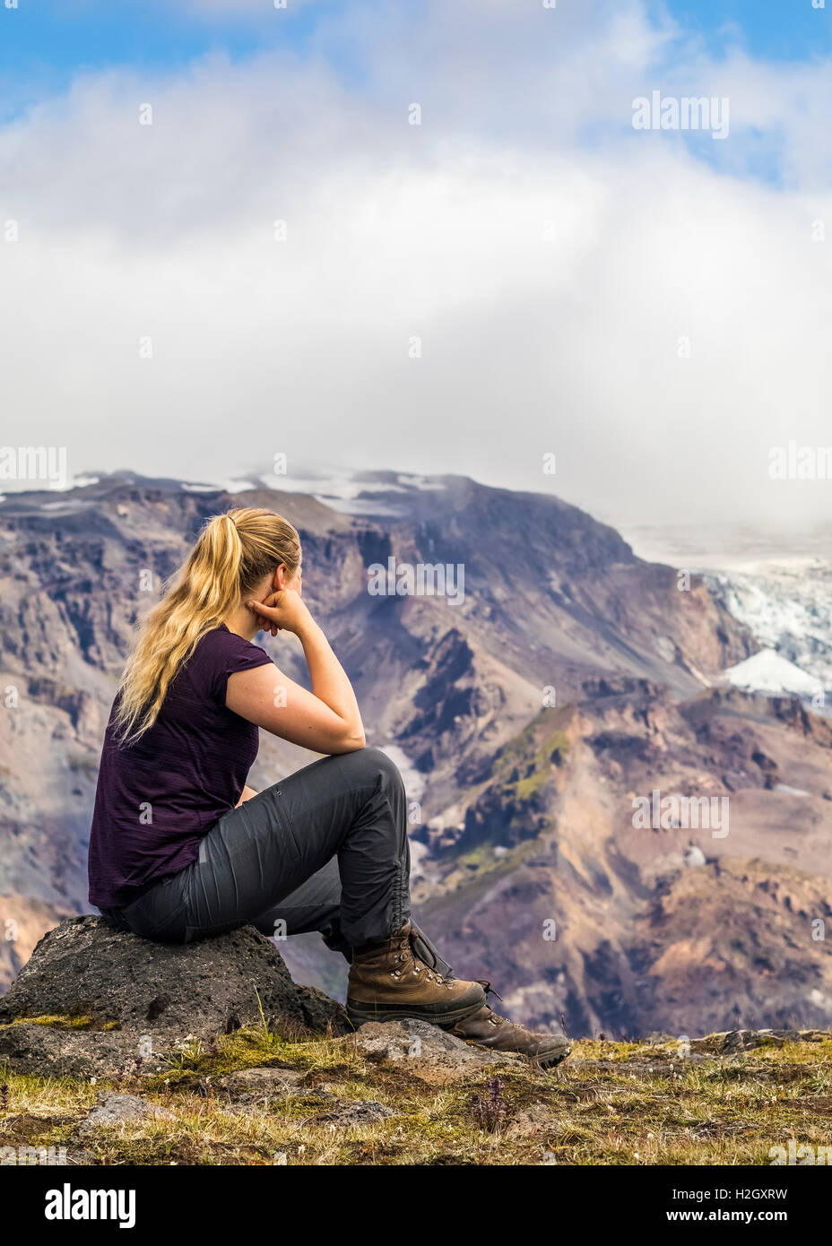 Young woman overlooking the mountains in Iceland. Stock Photo