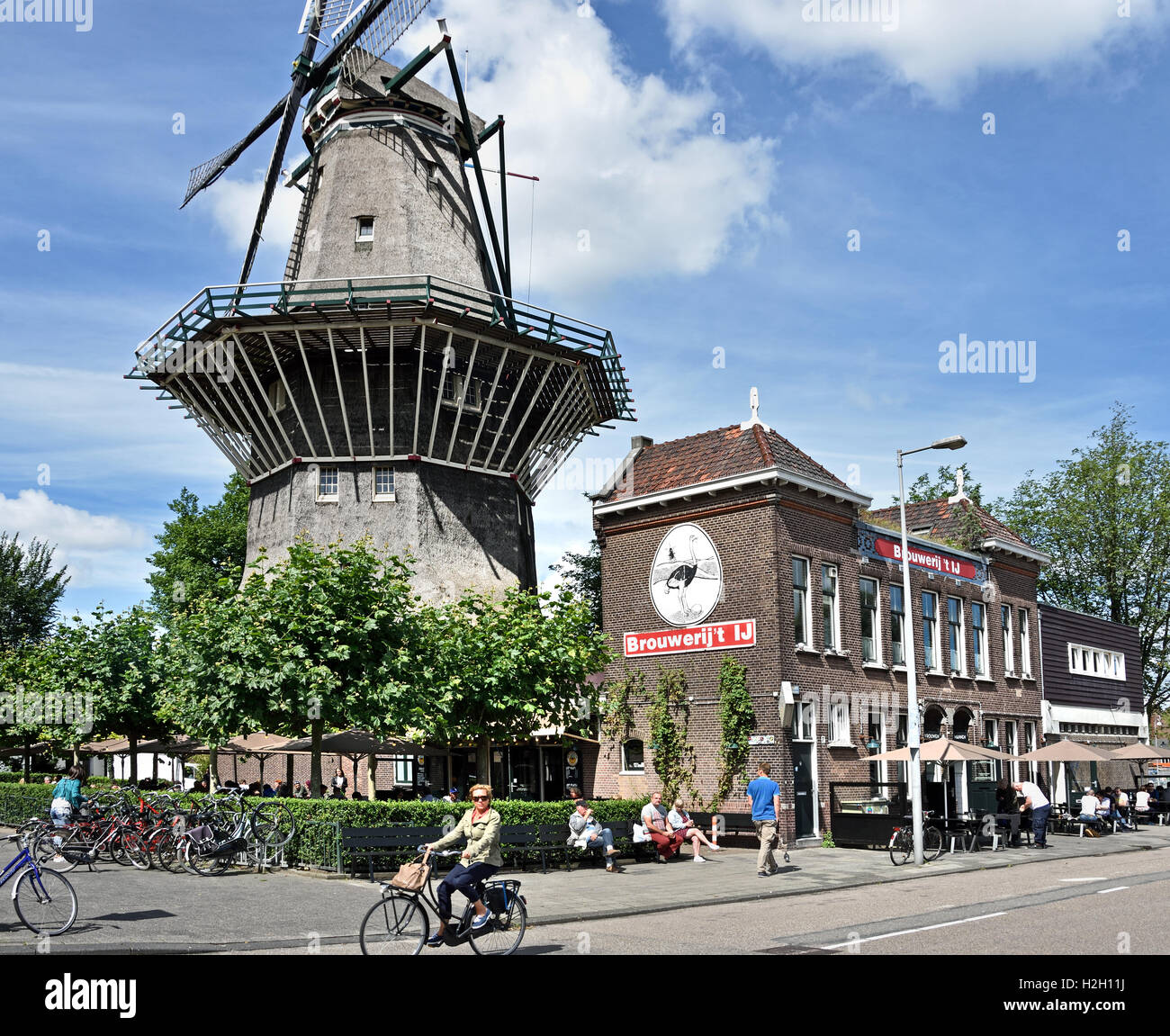 Brouwerij ‘t IJ bar pub which serves dutch beer brewed on-site, original brewery Amsterdam The Netherlands. Windmill Stock Photo