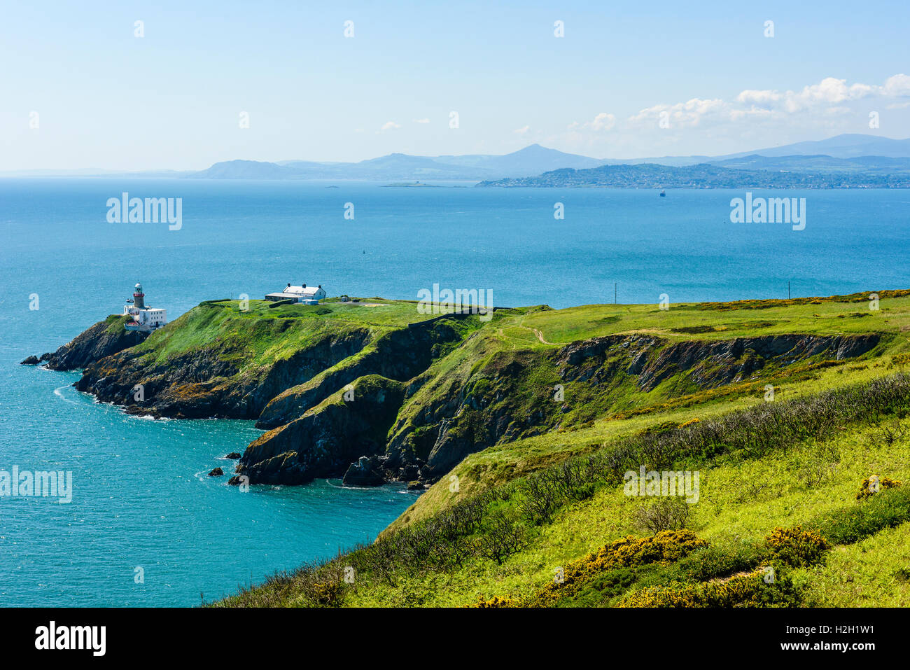 View from Howth Head across Dublin Bay Ireland, over Baily Lighthouse, Dalkey Head and Island to Wicklow Mountains on skyline Stock Photo