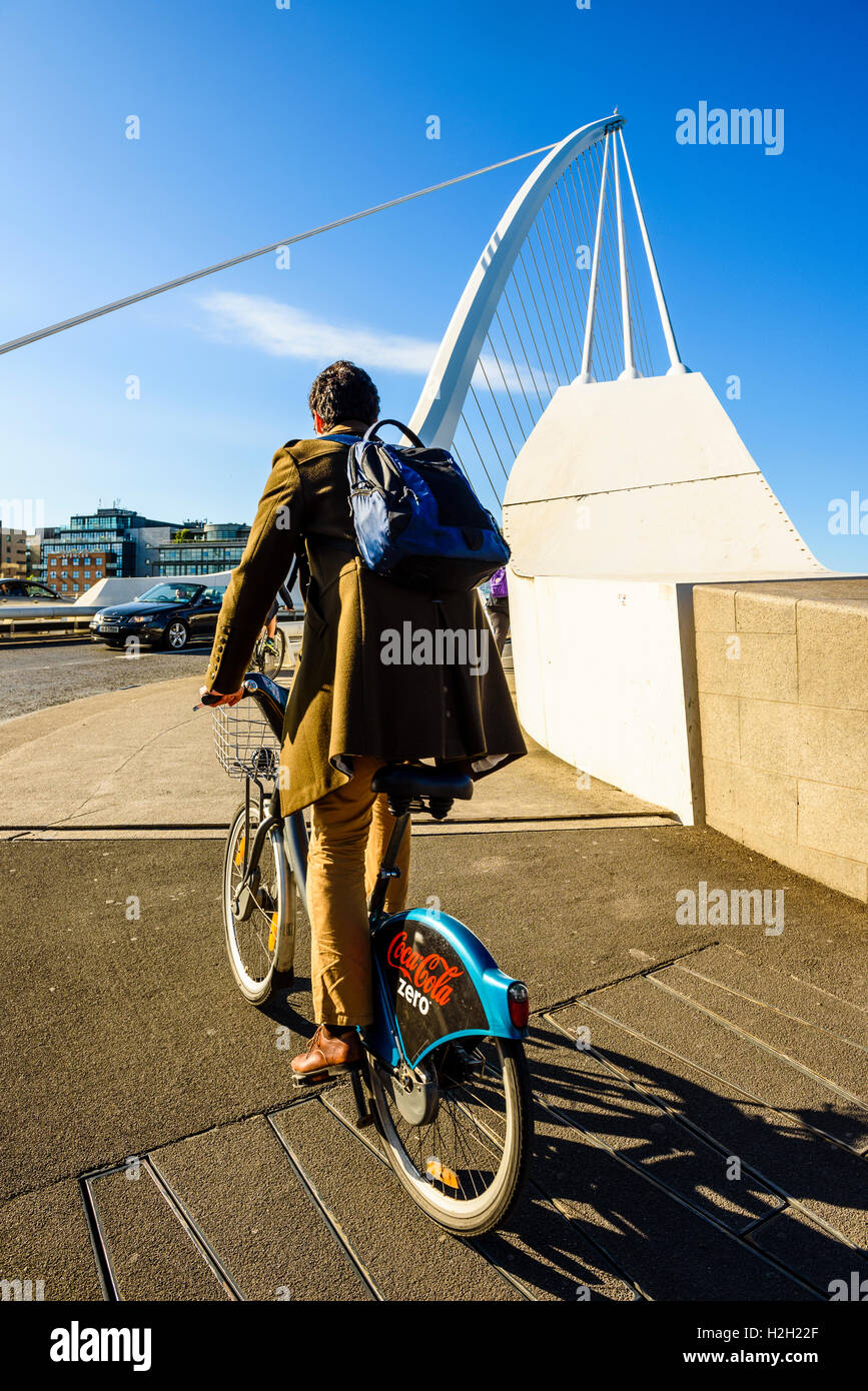Cyclist at south end of Samuel Beckett Bridge over River Liffey Dublin Ireland Stock Photo