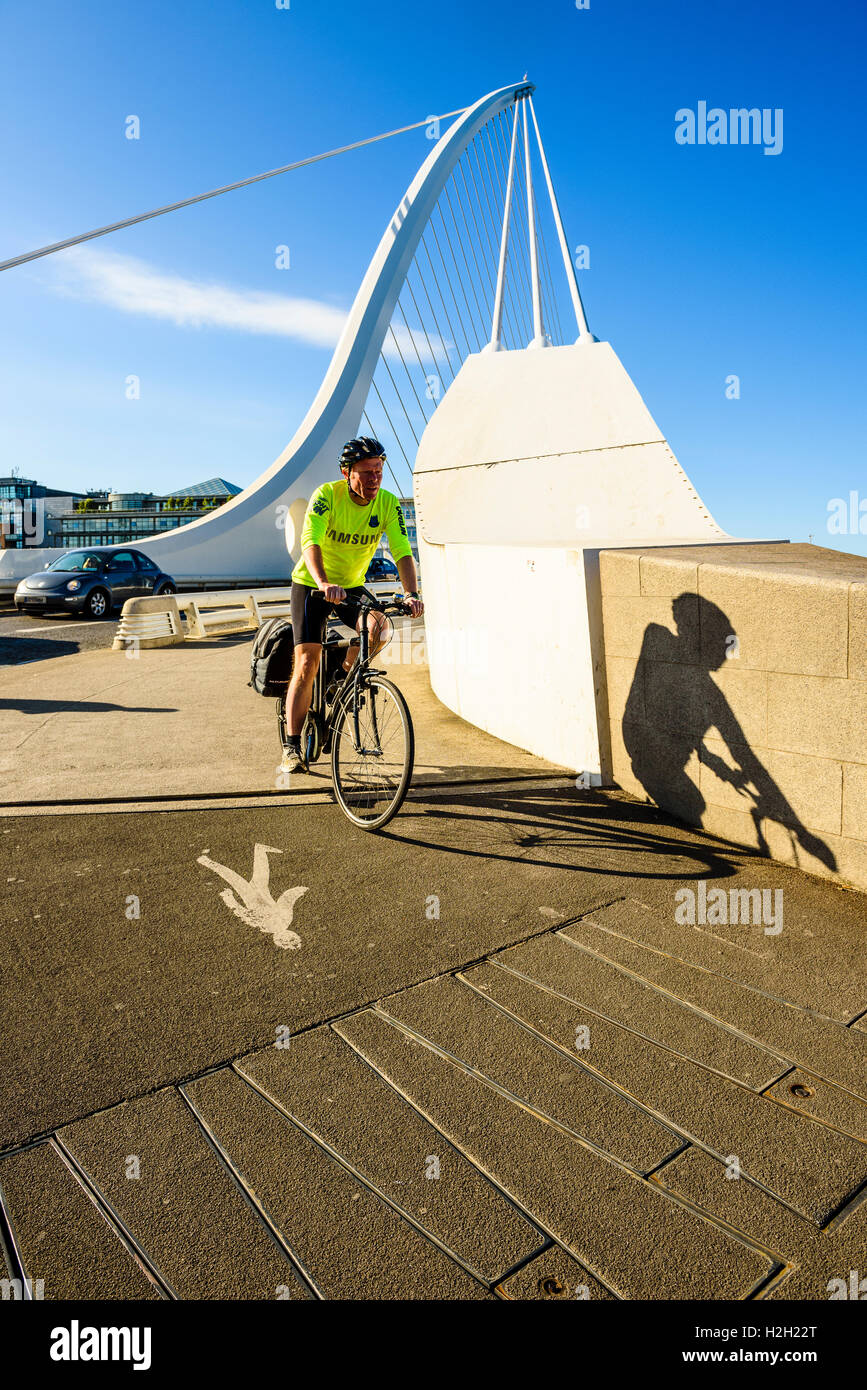 Cyclist at south end of Samuel Beckett Bridge over River Liffey Dublin Ireland Stock Photo