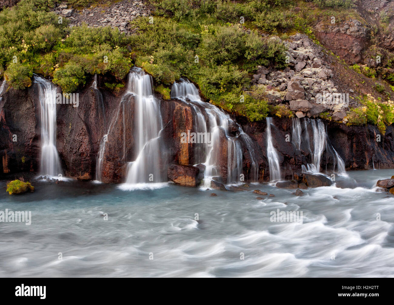 Hraunfossar in western Iceland in late summer. Long exposure to blur the fast moving water a bit. Stock Photo