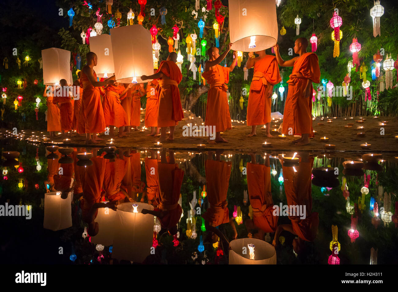 CHIANG MAI, THAILAND - NOVEMBER 07, 2014: Groups of Buddhist monks launch sky lanterns at the Yee Peng festival of lights. Stock Photo