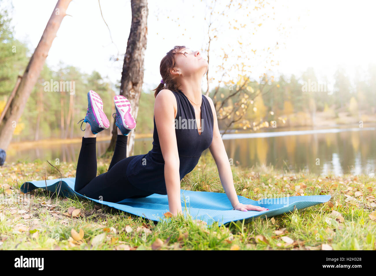 Beautiful woman practicing yoga lake hi-res stock photography and ...