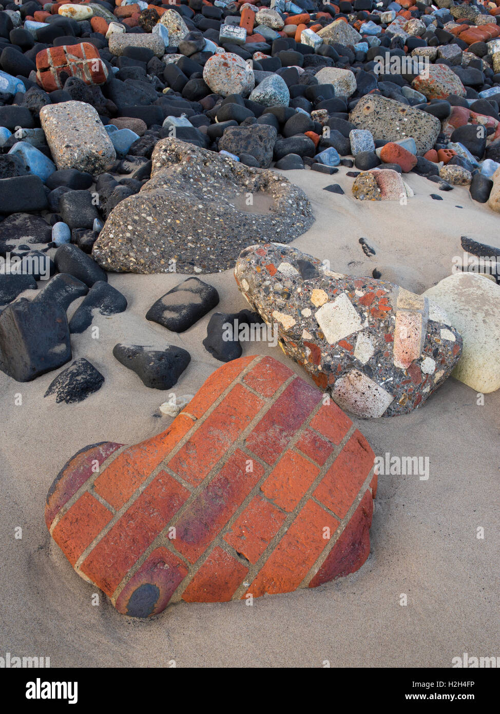 Industrial waste and litter strewn on the beach near Steetley Pier, Hartlepool, Teesside, Northeast of England, UK Stock Photo