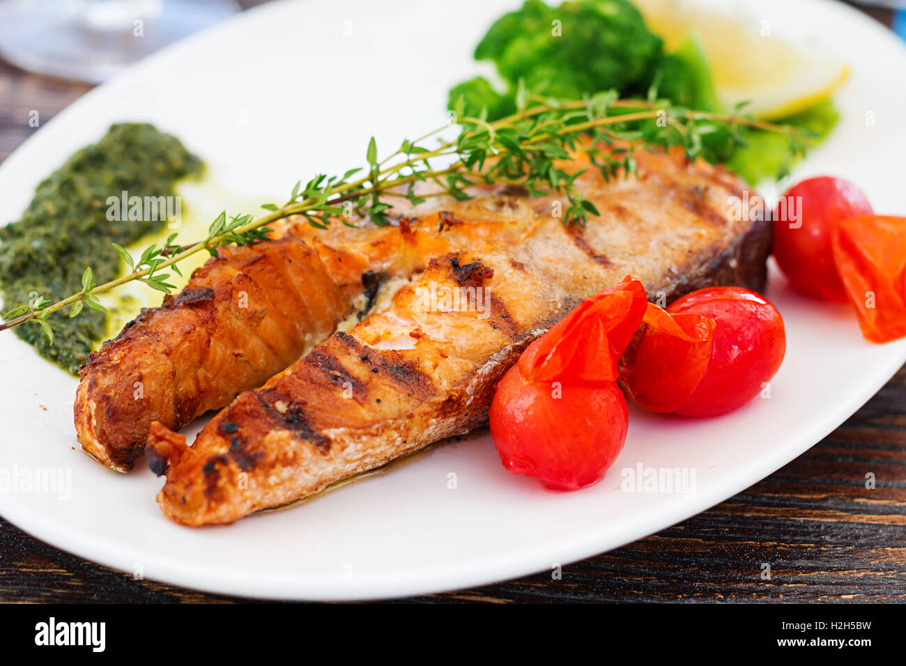 Grilled salmon steak with pesto sauce and vegetables Stock Photo - Alamy