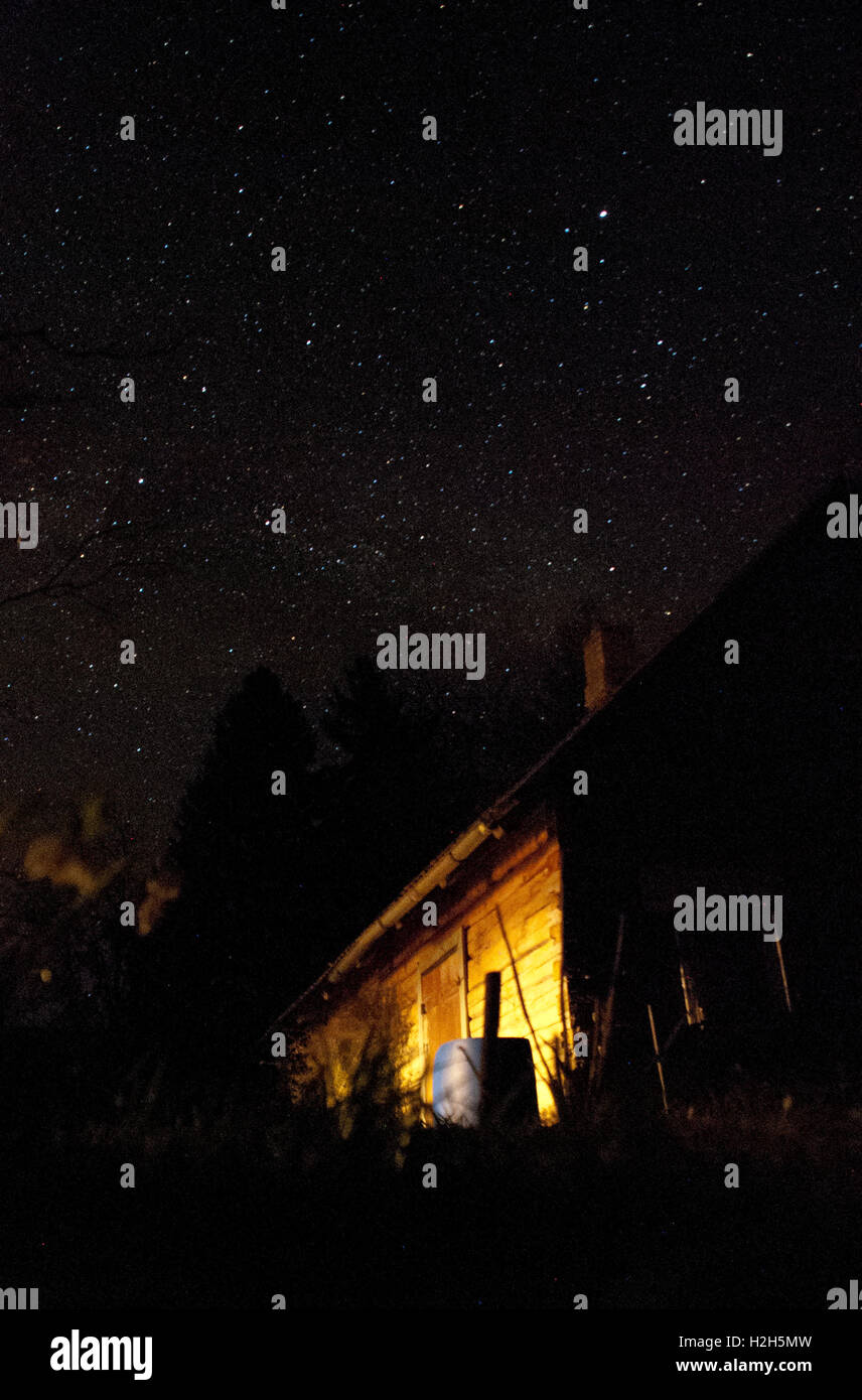 milky way in the nightsky and an old house Stock Photo