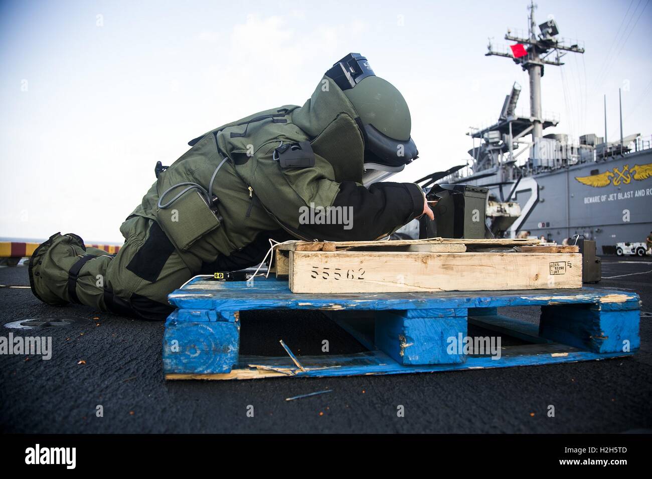 A U.S. Marine soldier inspects a simulated improvised explosive device during an IED training scenario aboard the USN Wasp-class amphibious assault ship USS Essex July 27, 2015 in the Indian Ocean. Stock Photo