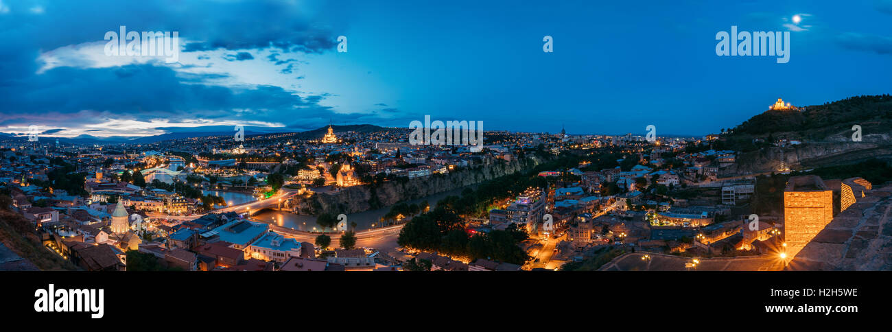 Tbilisi, Georgia. The Scenic Panoramic Top Field Of Vision. Cityscape In Evening Illumination With All Famous Landmarks And Sigh Stock Photo