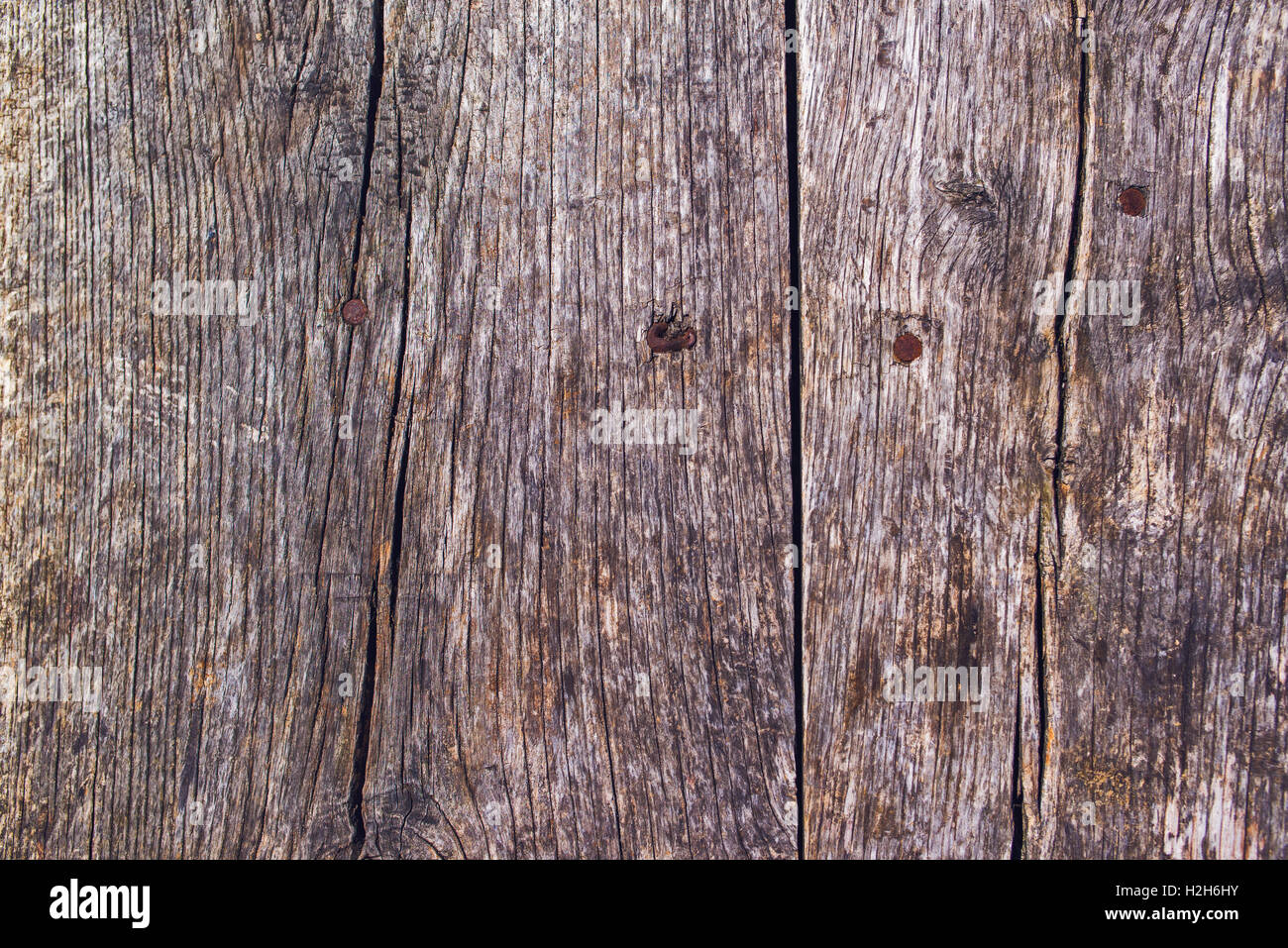 Rustic wooden surface with rusty nails, top view Stock Photo