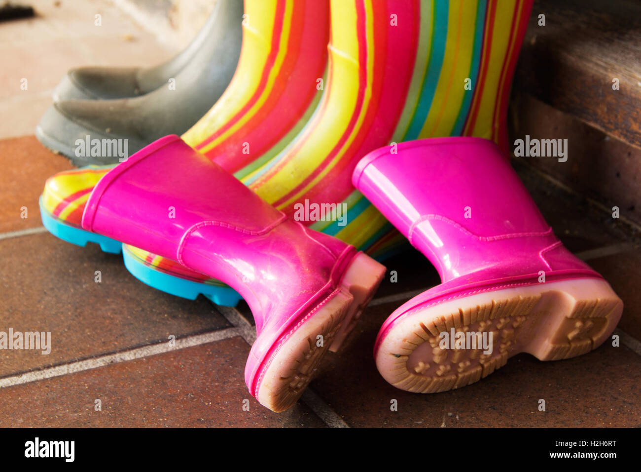 Colourful wellington boots left outside on a doorstep Stock Photo - Alamy