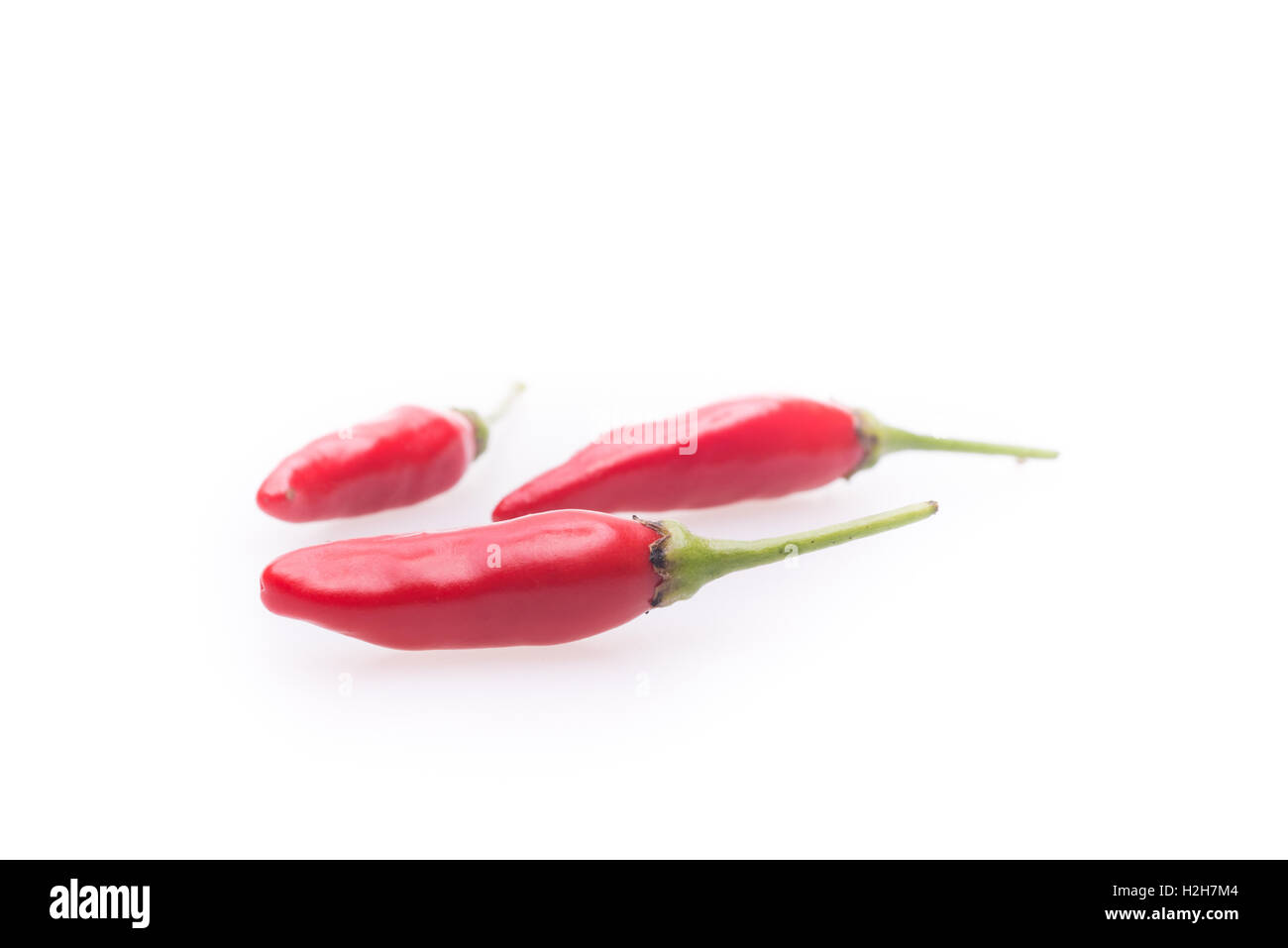 Spicy hot chili peppers on white background Stock Photo