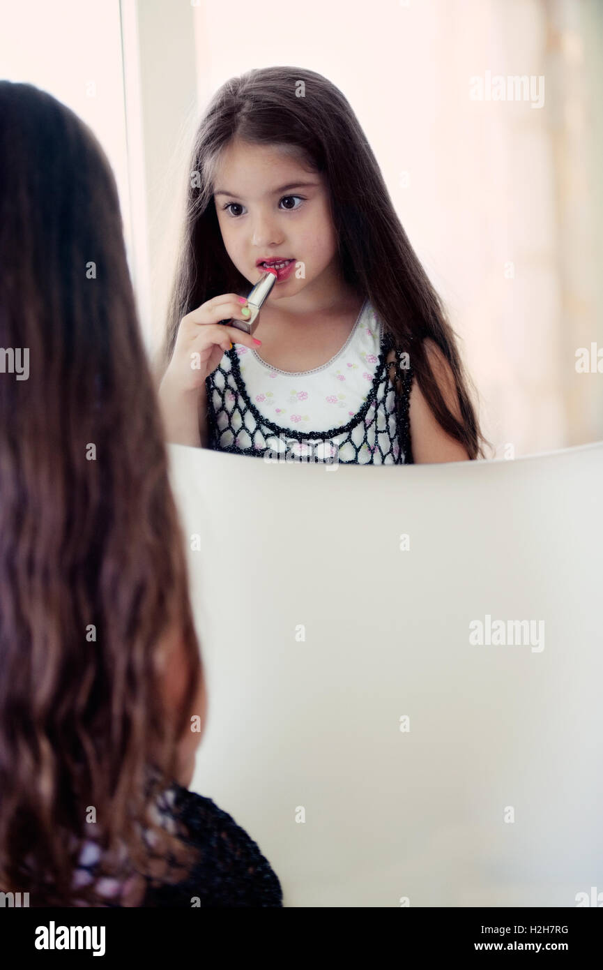 Little girl applying lipstick Stock Photo Alamy