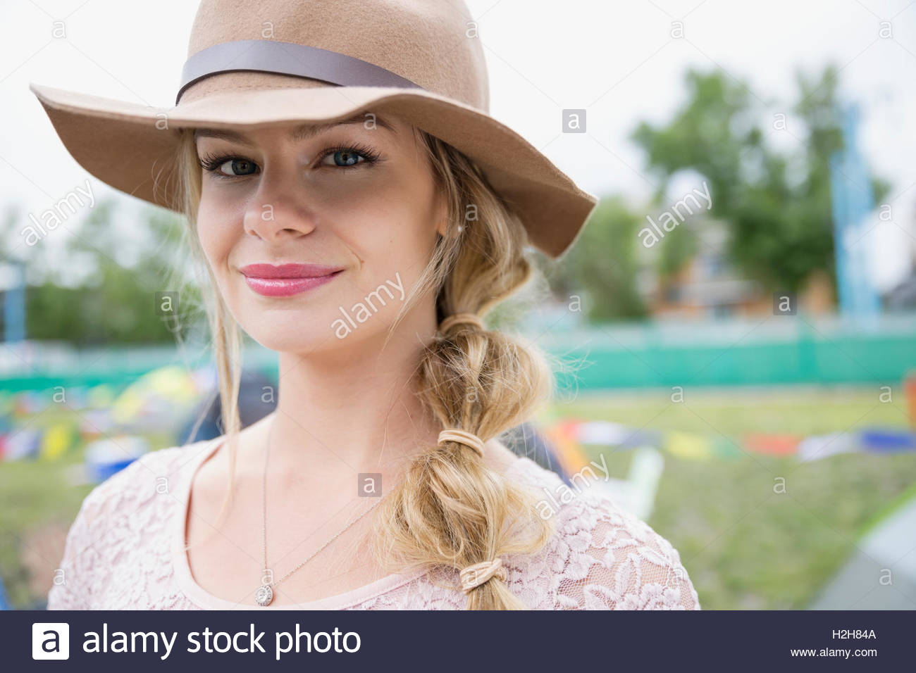 Unrecognisable caucasian blonde woman wearing white hat and beige