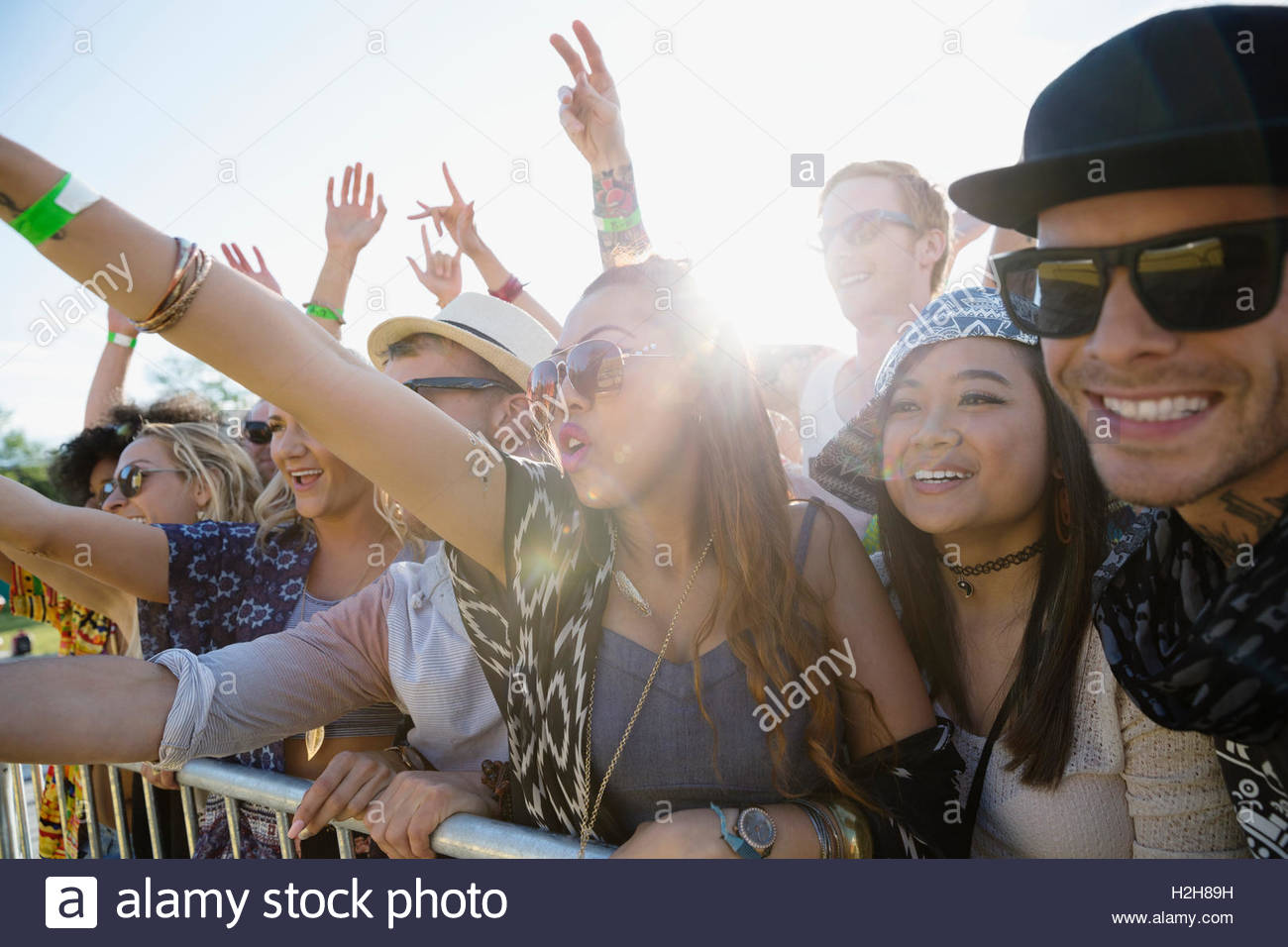 Young crowd cheering at summer music festival Stock Photo