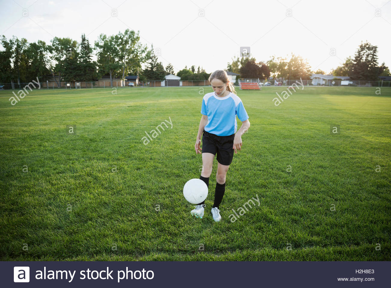 Middle school girl soccer player practicing juggling soccer ball on field Stock Photo Alamy
