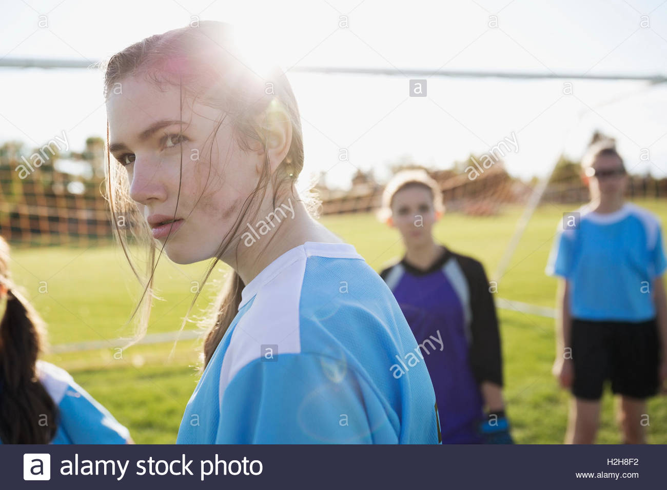 Serious middle school girl soccer player showing attitude on sunny