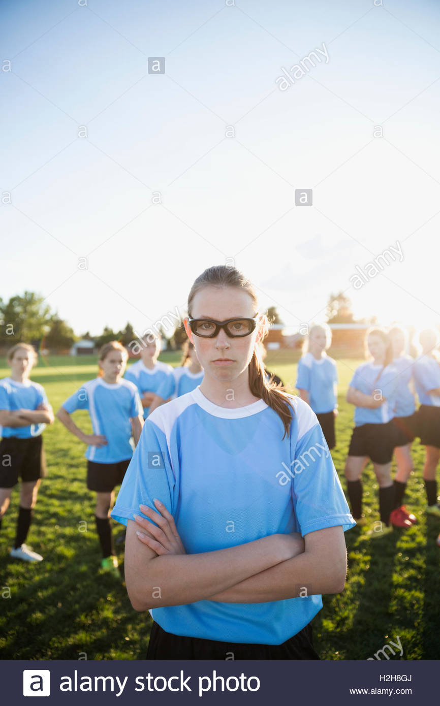 Portrait confident middle school girl soccer player showing attitude