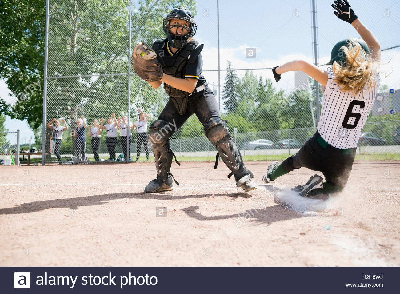Girl softball player sliding into base hires stock photography and