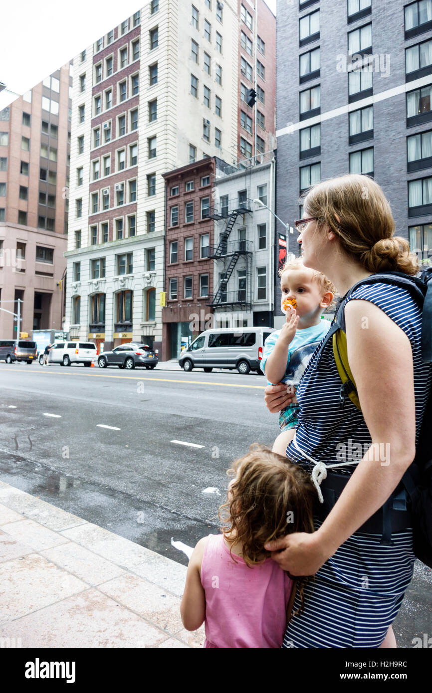 New York City,NY NYC,Lower Manhattan,Water Street,buildings,traffic,adult adults,woman women female lady,girl girls,youngster youngsters youth youths Stock Photo