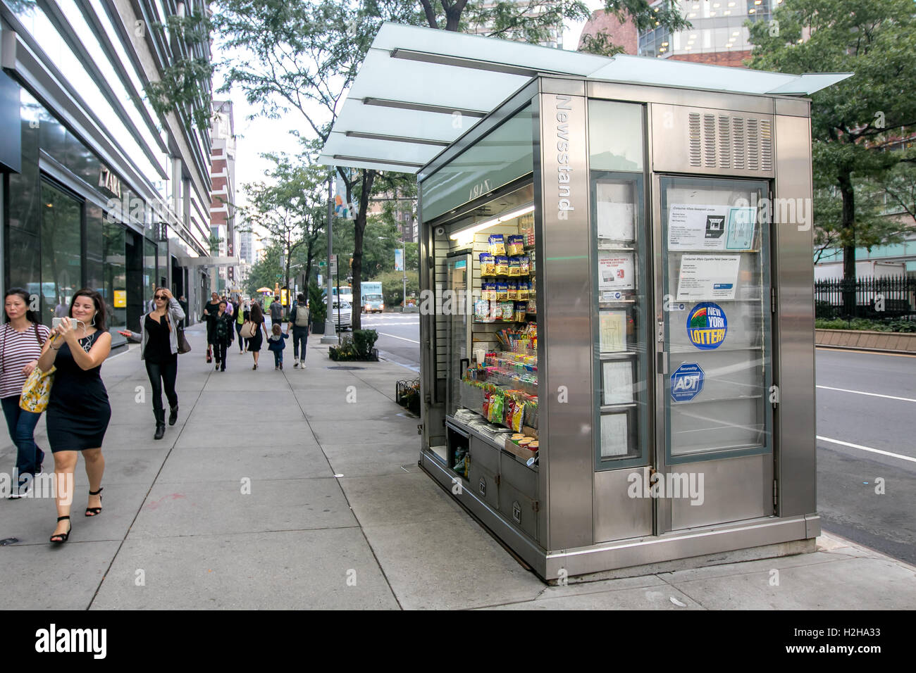 People walk by a newsstand in Manhattan. Stock Photo