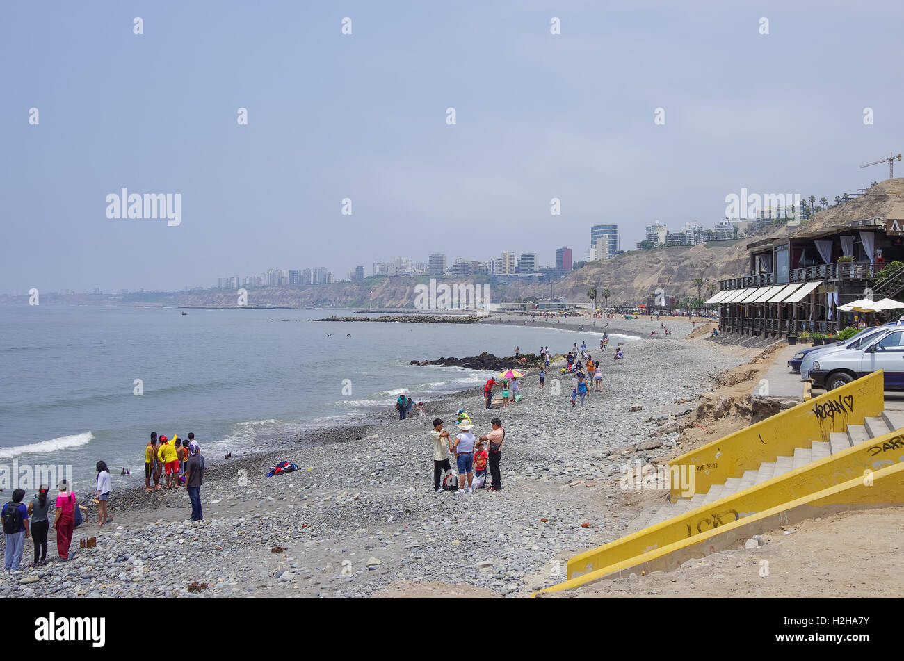 Lima, Peru - January 1, 2014: People on the public city ocean beach in Barranco district. Stock Photo